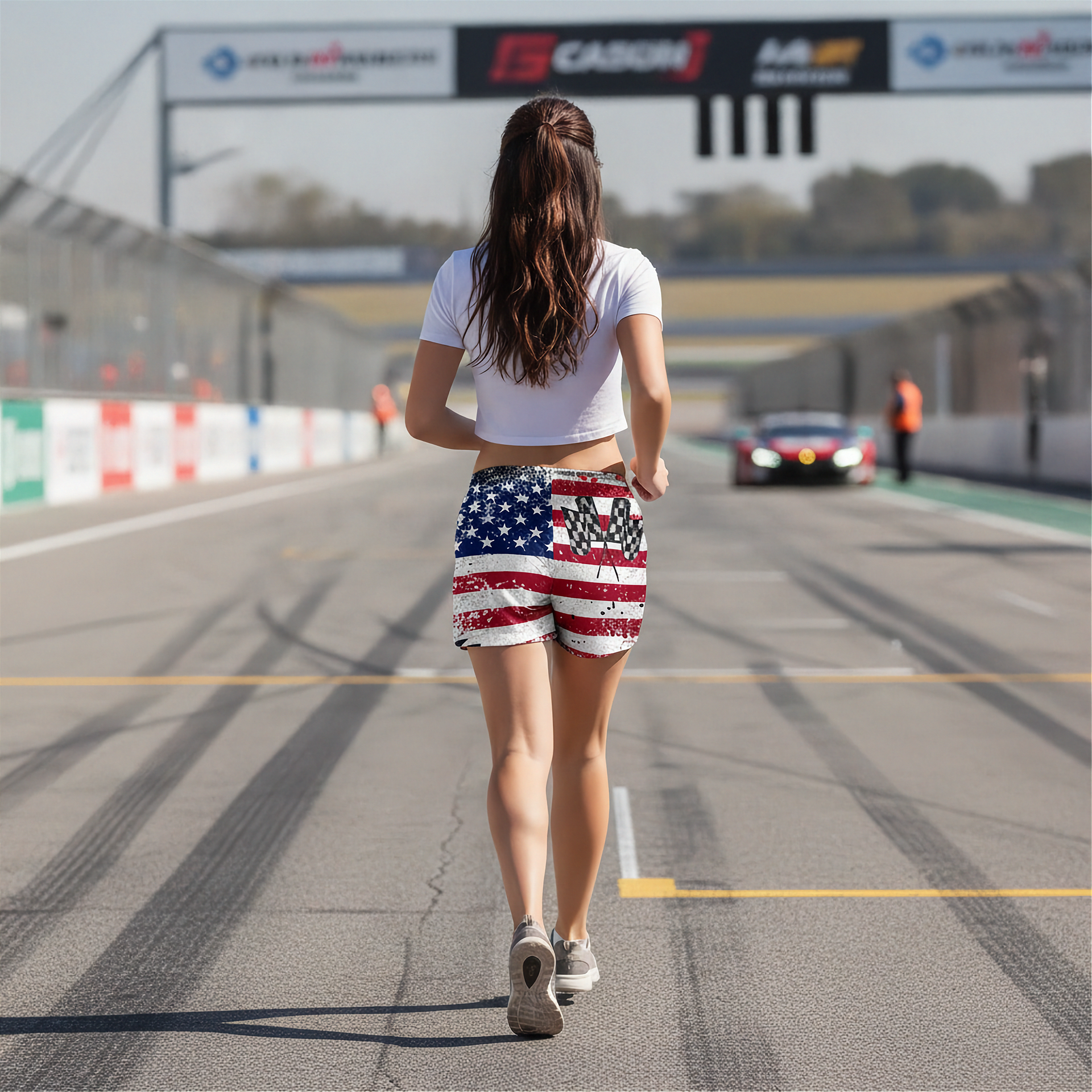 Woman walking on a race track wearing American flag shorts.