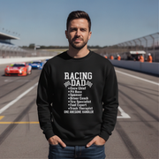 Man wearing a black sweatshirt with 'Racing Dad' text on a race track background
