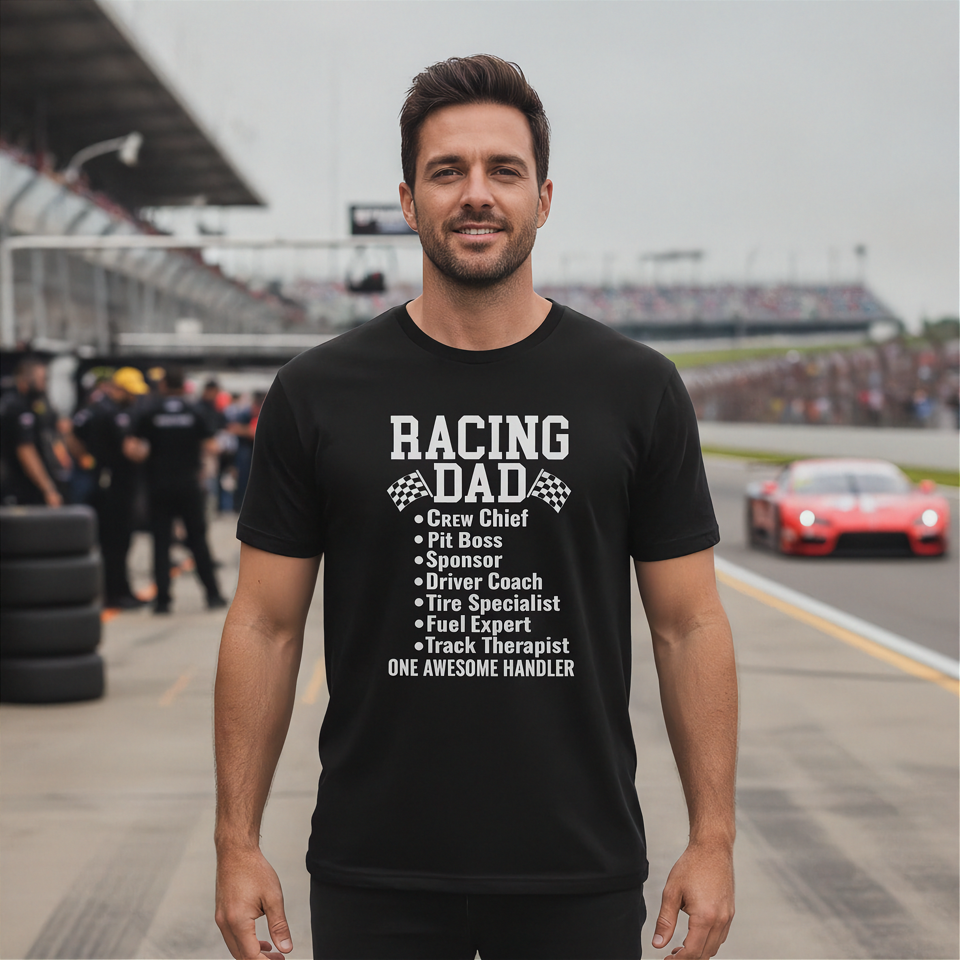 Man wearing a black t-shirt with 'Racing Dad' text at a race track.