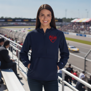 Woman wearing a navy blue sweatshirt with a red heart logo at a race track.