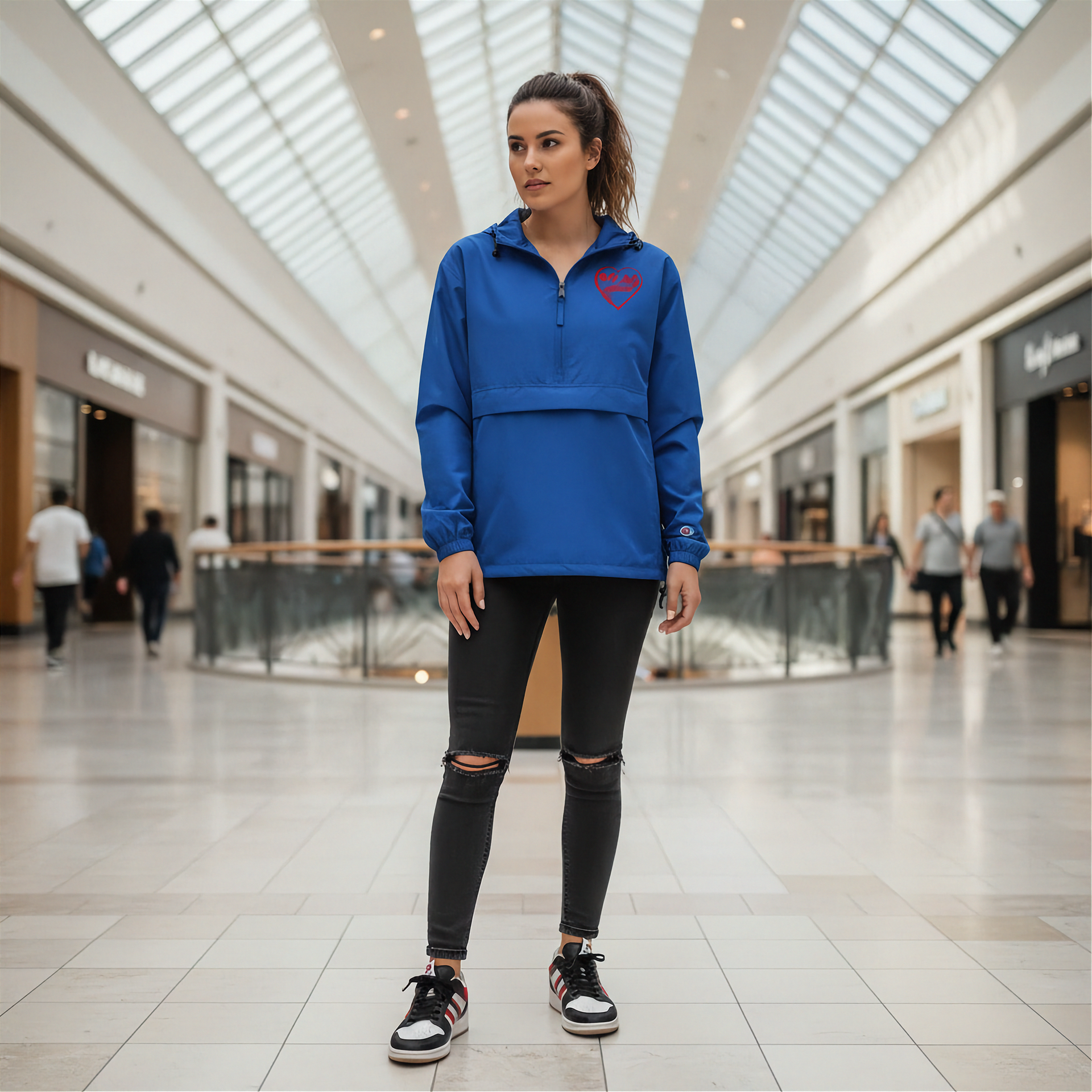 Woman wearing a blue jacket with a heart design in a mall