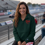 Woman wearing a green sweatshirt with a heart design on a race track