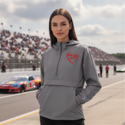 Woman wearing a gray jacket with a red racing daughter heart design on a race track