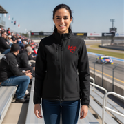 Woman wearing a black jacket with a red racing daughter heart design at a race track