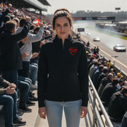 Woman in a black jacket with a red racing daughter heart design at a race track event