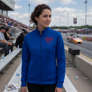Woman wearing a blue jacket with a red racing daughter heart design at a race track
