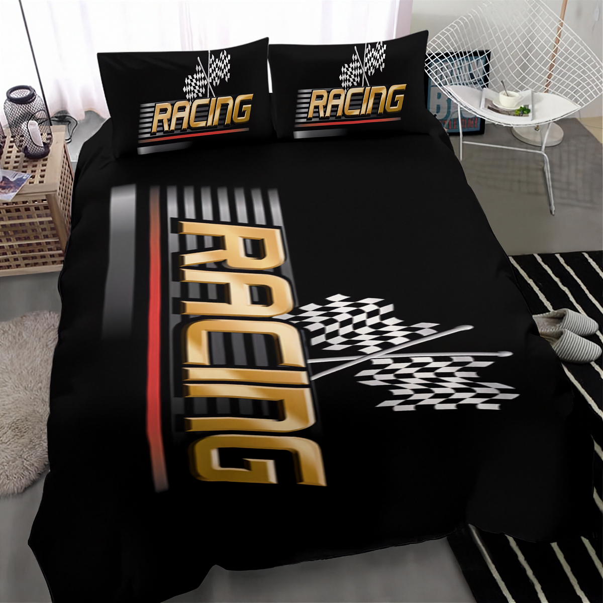 A black racing-themed bedding set including a duvet cover and two matching pillowcases, displayed on a bed in a modern bedroom setting. The design features a large gold and black 3D 'RACING' text graphic, a checkered flag motif, and a red and black stripe accent.
