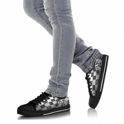 Checkered sneakers worn with gray jeans on a white background