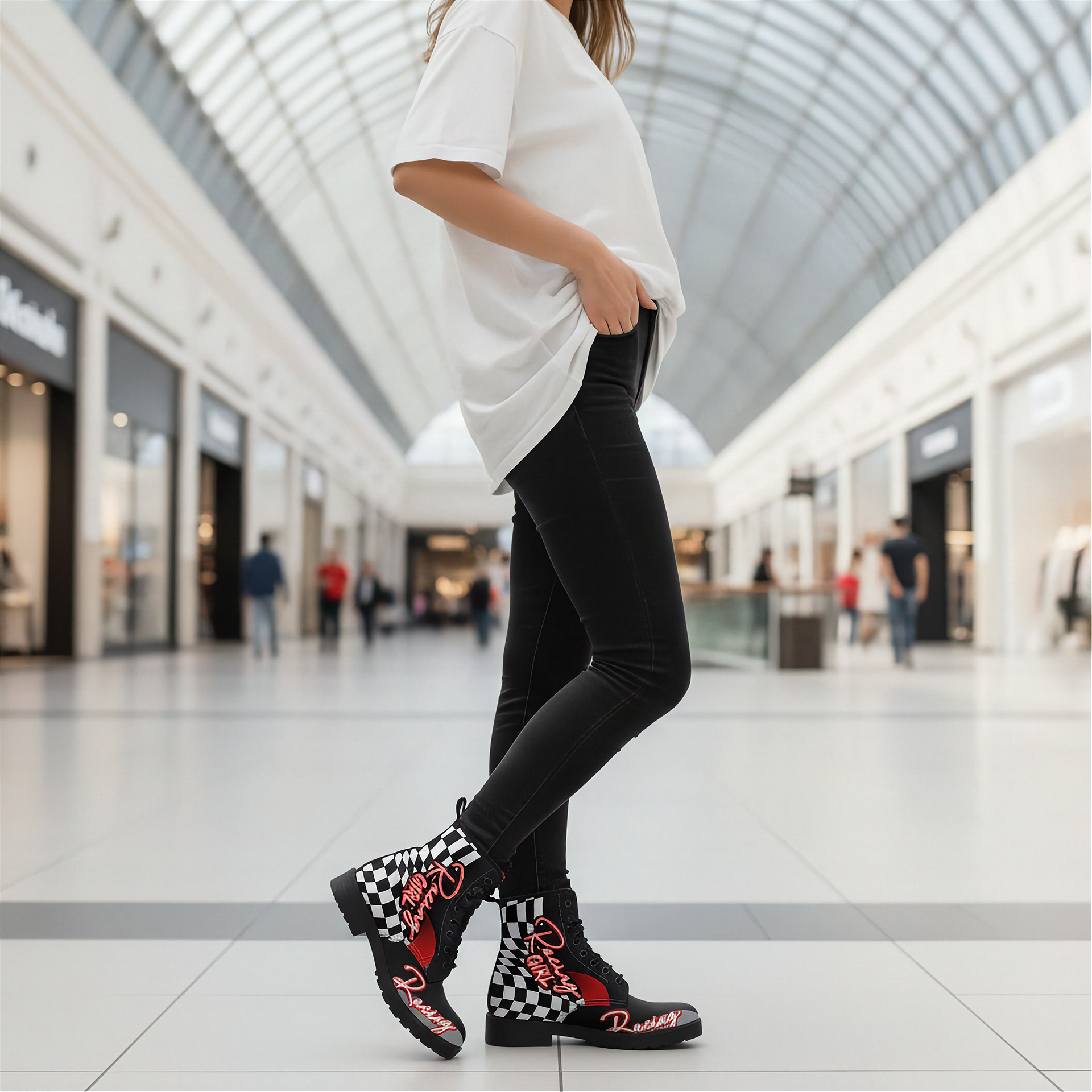 Person wearing black checkered boots with red accents in a mall setting