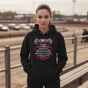Woman wearing a black hoodie with a graphic design at a race track.