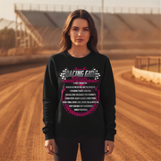 Woman wearing a black sweatshirt with 'Racing Girl' design on a race track.