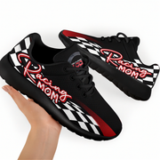 Black sneakers with 'Racing Mom' text and checkered pattern held by a hand on a white background