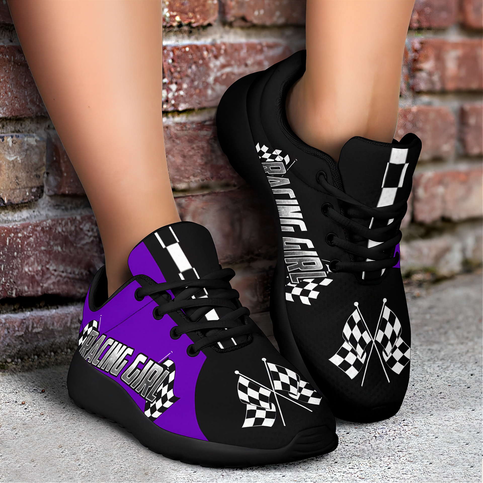 Black and purple sneakers with racing girl text and checkered flags on a brick background