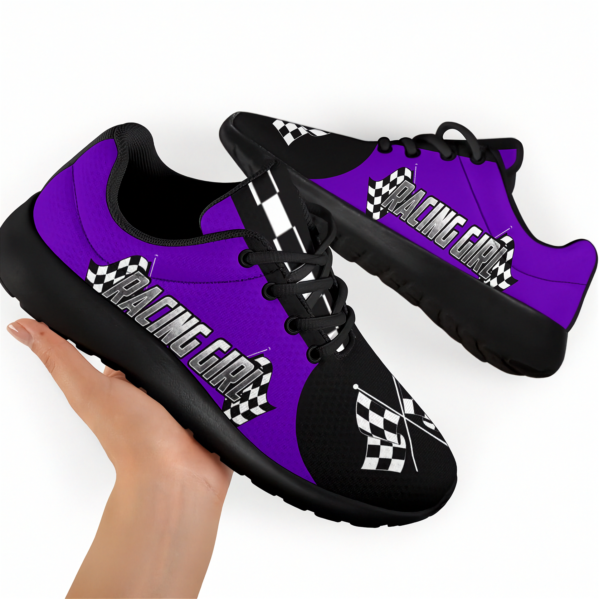 Purple and black sneakers with 'Racing Girl' text held by a hand on a white background