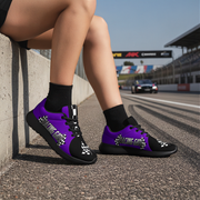Woman wearing purple and black sneakers with a racing track in the background