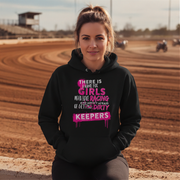 Woman wearing a black hoodie with dirt racing text in a dirt track setting
