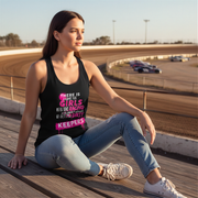 Woman sitting on a track wearing a tank top with text, with race cars in the background.