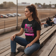Woman sitting on a wooden bench at a race track wearing a black t-shirt with pink text.