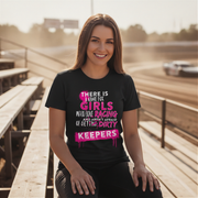Woman wearing a black dirt track racing t-shirt with colorful text at a race track.