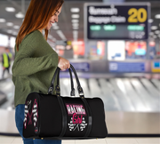 Woman holding a black duffel bag with 'Racing Girl' design at an airport.