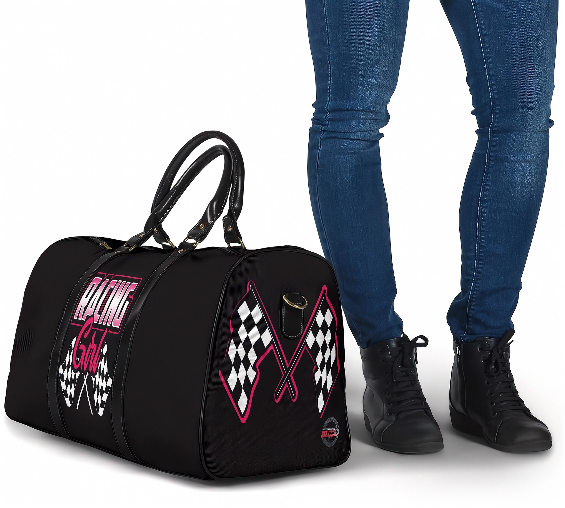 Black duffel bag with racing design next to a person wearing blue jeans and black shoes.
