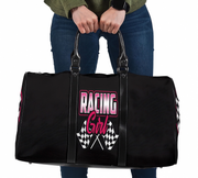 Black duffel bag with 'Racing Girl' text and checkered flags held by a person.