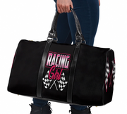 Black duffel bag with 'Racing Girl' text and checkered flags held by a person.
