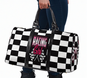 Checkered duffel bag with 'Racing Girl' text held by a person on a white background