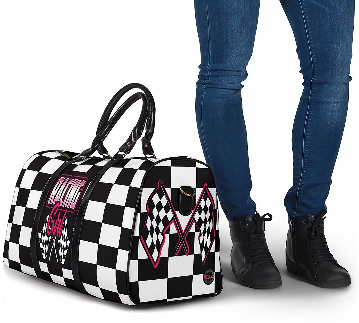Black and white checkered bag with racing design next to a person wearing blue jeans and black shoes.