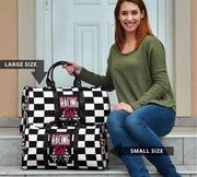 Woman holding a large and small checkered bag with 'Racing Girl' text, sitting on steps.