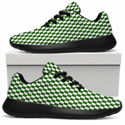 A pair of low-top sneakers with a green and white checkerboard pattern on the uppers, black laces, and black soles, displayed on and around a white shoebox against a white background.