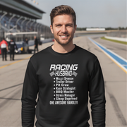 Man wearing a black sweatshirt with 'Racing Husband' text on a race track background