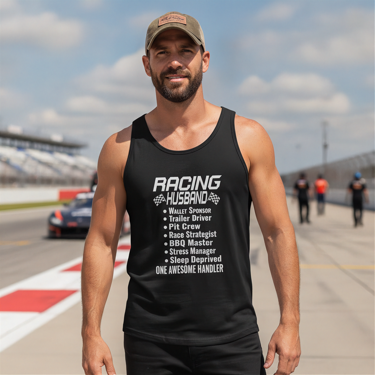 Man wearing a black tank top with Racing Husband on a race track