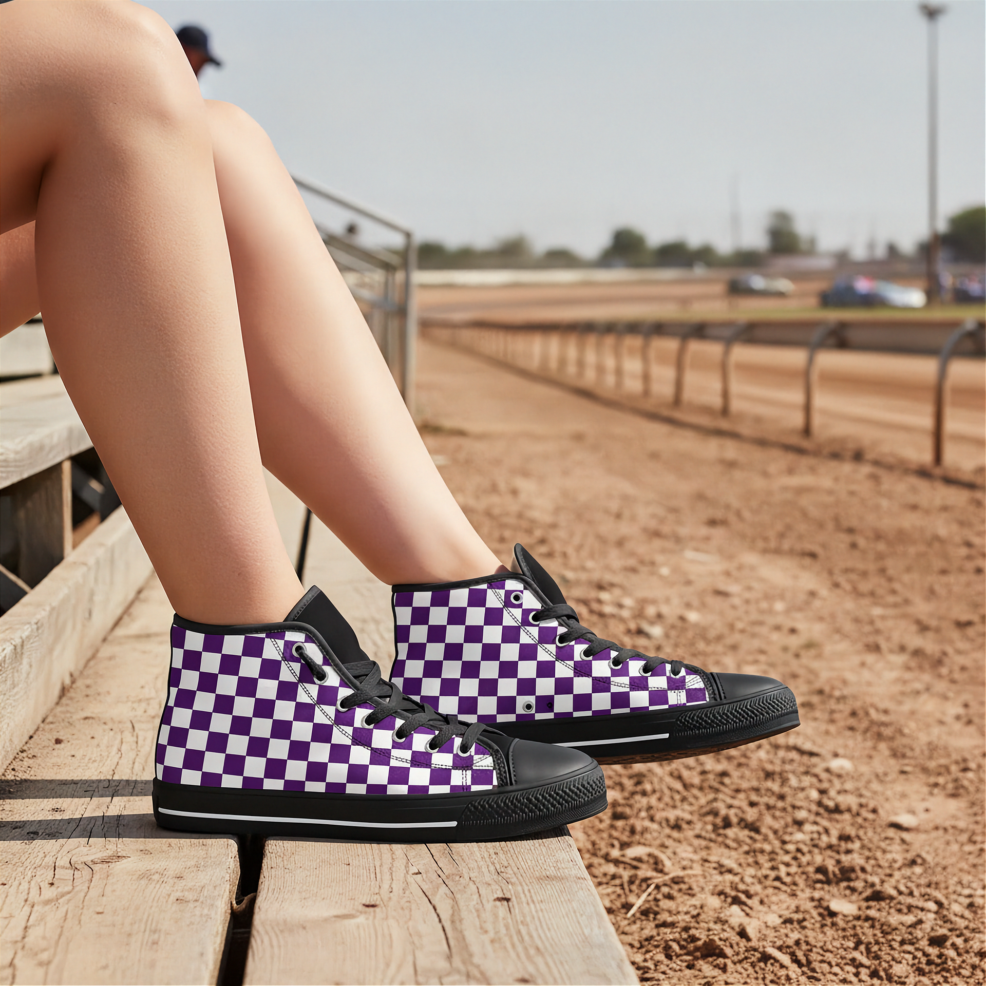 Person wearing purple and black checkered sneakers on a wooden platform with a race track background.