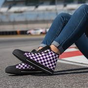 Person wearing purple checkered shoes on a race track