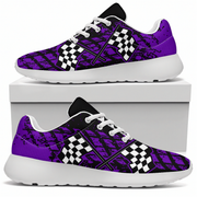 A pair of low-top sneakers shown on a white background, with one shoe resting on top of a white box and the other below. The shoes have a purple and black distressed graphic pattern with white checkered flag motifs on the sides and white soles.