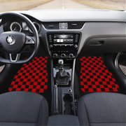 photo of the interior of a car showing a checkered black and red car mats on the front