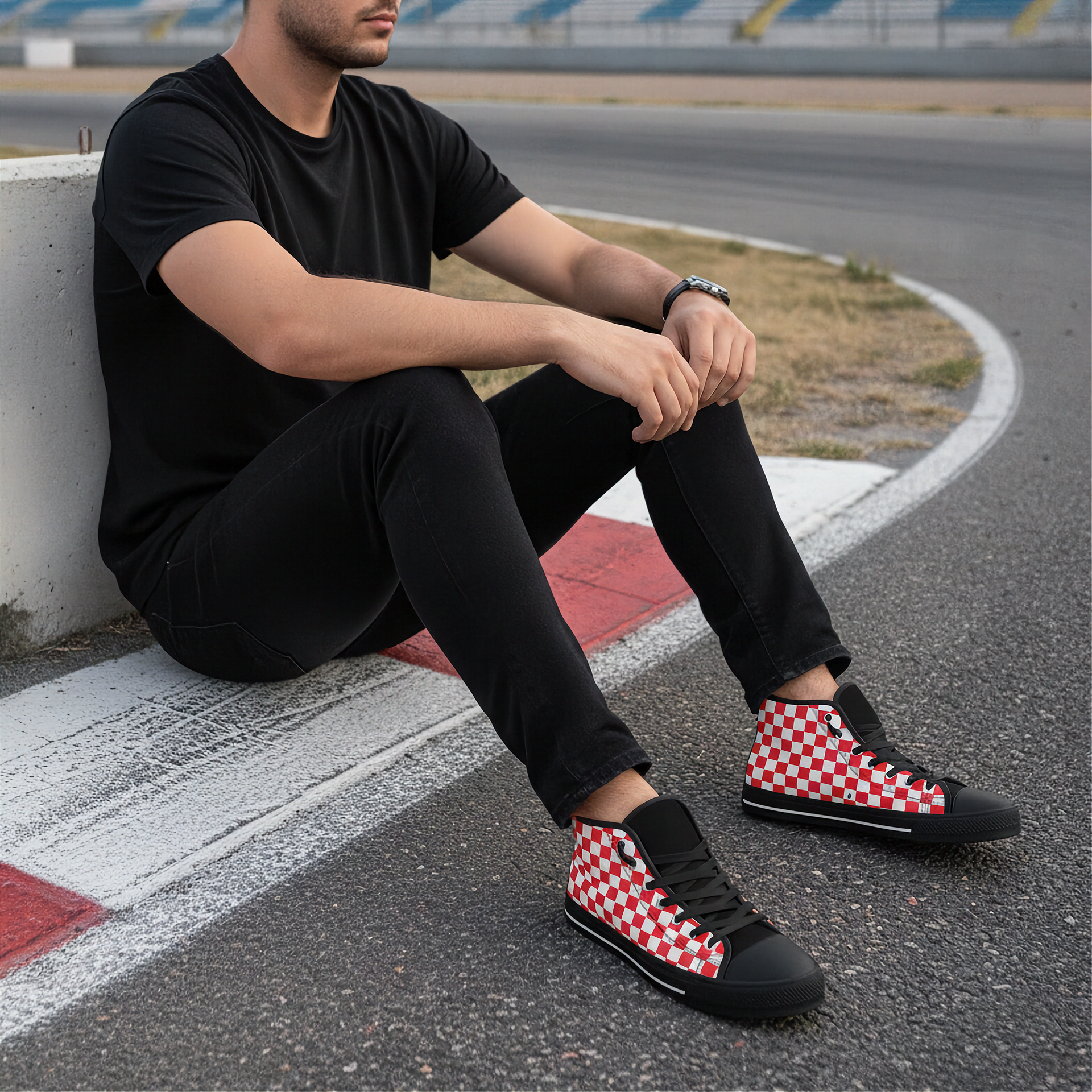 Person wearing black checkered shoes sitting on a race track.