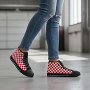 Red and white checkered high-top shoes worn with blue jeans indoors.