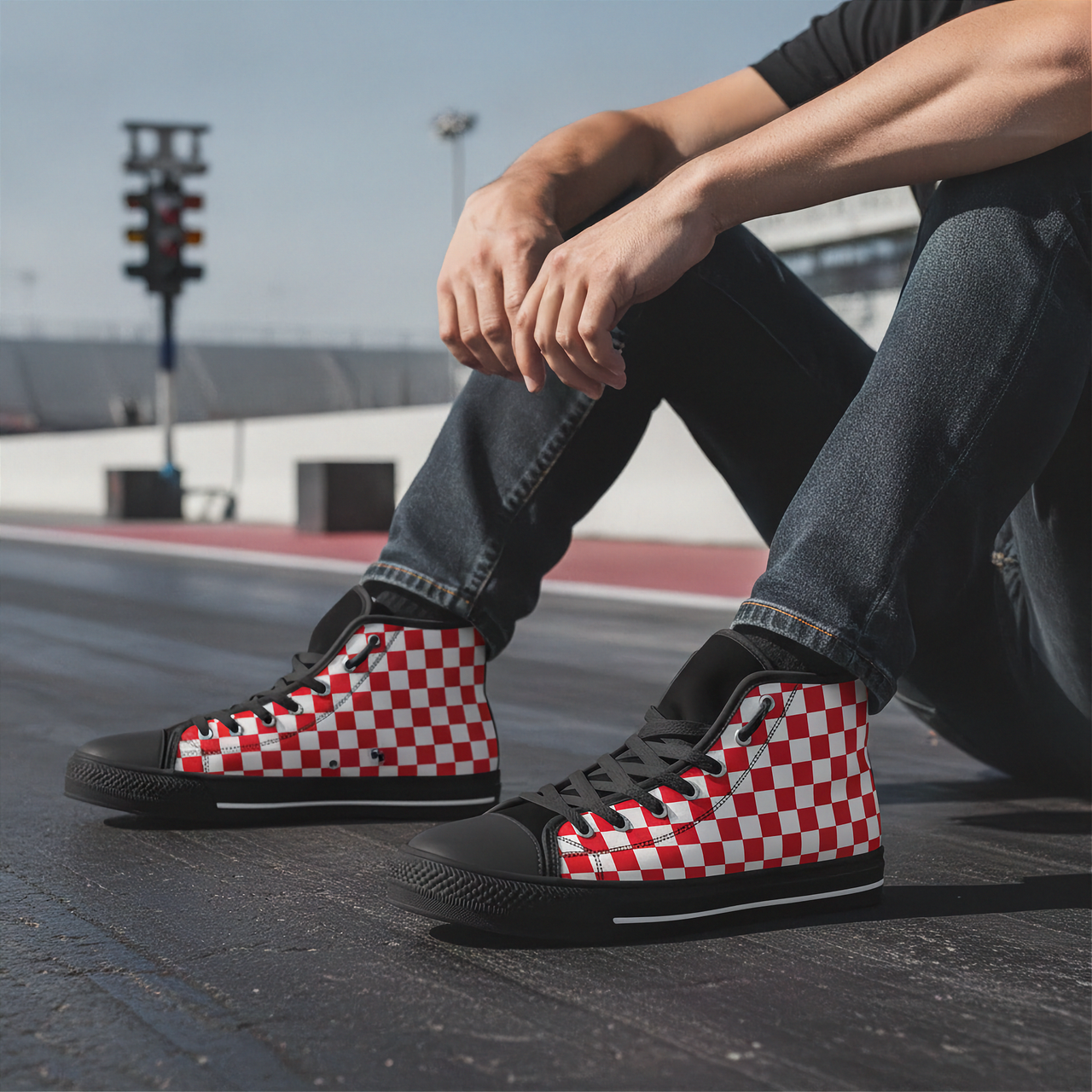 Person wearing red and white checkered high-top shoes on a track.
