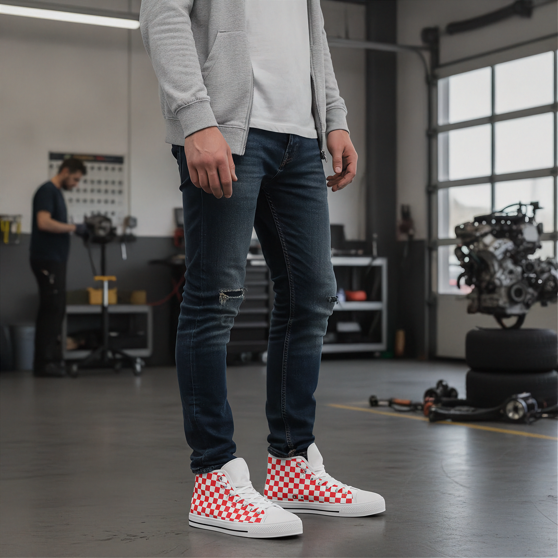 Person wearing blue jeans and red checkered shoes in a workshop setting