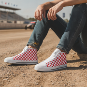Person wearing red and white checkered sneakers on a dirt track