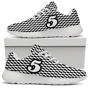 Green sneakers with white soles on a white box against a white background