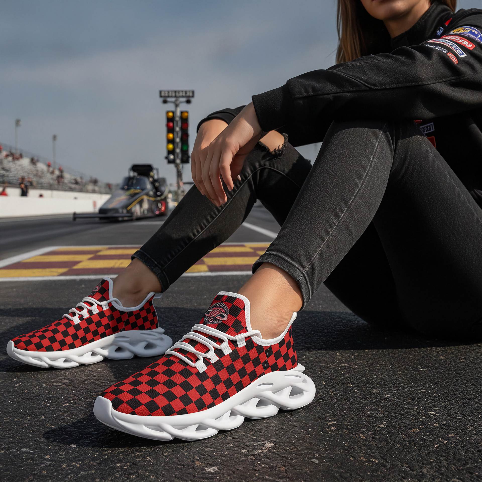 Person wearing red and black checkered sneakers on a race track.
