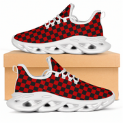 Red and black checkered sneakers with white soles on a beige box.