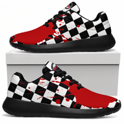 A pair of low-top sneakers displayed on and above a white shoebox. The shoes feature a bold red and black-and-white checkerboard pattern with red paint splatter details on a clean white background.