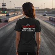  wearing a black shirt with humorous drag racing quote text on a race track