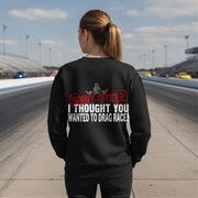 Woman wearing a black sweatshirt with humorous drag racing quote text on a race track