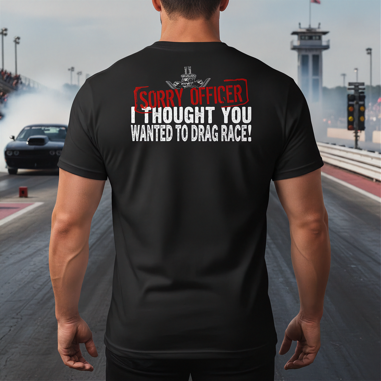 Man wearing a black t-shirt with humorous drag racing text on a race track background