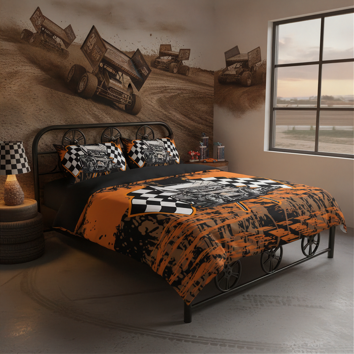 A racing-themed bedding set displayed on a bed in a styled bedroom. The comforter and matching pillow shams feature a bold orange, black, and white graphic design with checkered accents, set against a wall mural of dirt race cars.